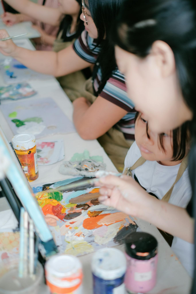 Children painting together at an art workshop, enjoying creative expression with vibrant colors.